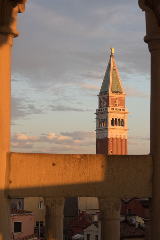 El Campanile de San Marco al atardecer visto entre columnas